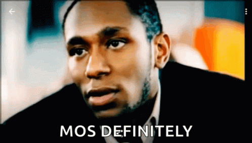 A Man In A Suit And Tie With The Words " Mos Definitely " Next To Him GIF