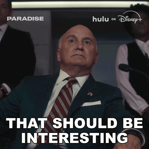 A Man In A Suit And Tie With The Words That Should Be Interesting Below Him GIF