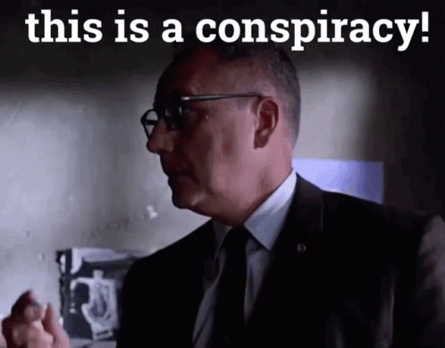 A Man In A Suit And Tie With The Words This Is A Conspiracy Below Him GIF