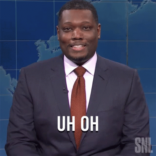 A Man In A Suit And Tie With The Words Uh Oh On His Chest GIF
