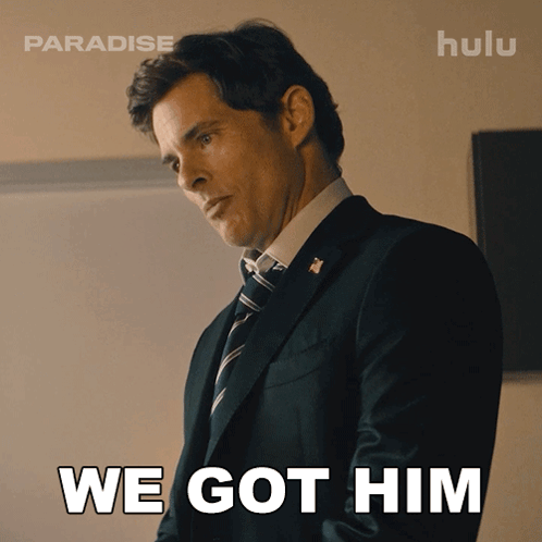 A Man In A Suit And Tie With The Words We Got Him Behind Him GIF