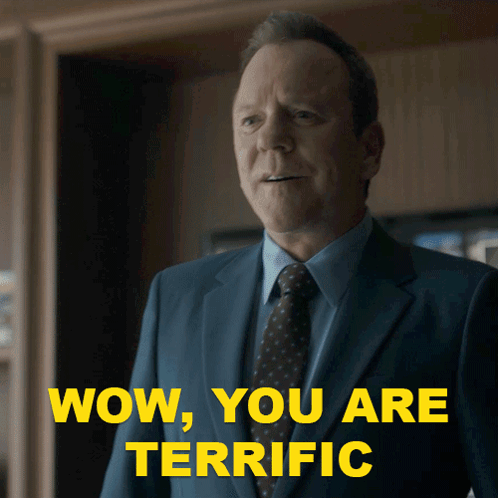 A Man In A Suit And Tie With The Words Wow You Are Terrific Behind Him GIF