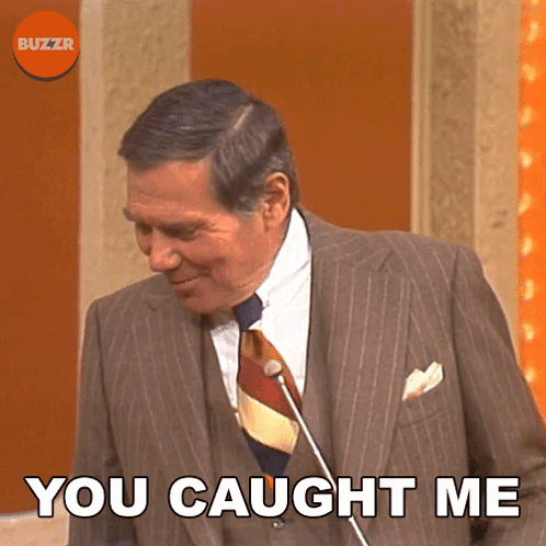 A Man In A Suit And Tie With The Words You Caught Me Below Him GIF