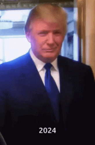 A Man In A Suit And Tie With The Year 2024 Written On The Bottom GIF