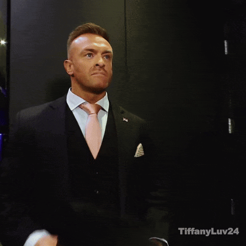 A Man In A Suit And Tie With Tiffanyluv24 Written On The Bottom Right GIF