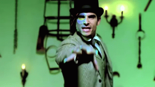 A Man In A Suit And Top Hat Is Pointing GIF