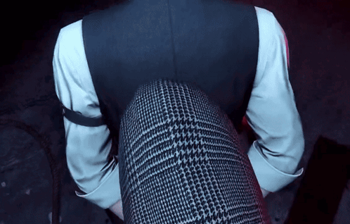A Man In A Suit And White Shirt Is Sitting On A Woman 'S Lap GIF