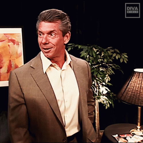A Man In A Suit And White Shirt Is Standing In Front Of A Diva Studio Logo GIF