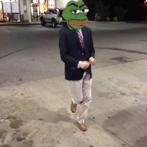A Man In A Suit Has A Green Frog Head On His Head GIF