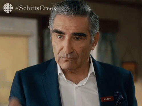 A Man In A Suit Has A Name Tag That Says Johnny On It GIF