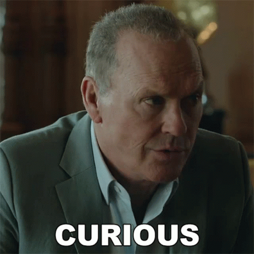 A Man In A Suit Has The Word Curious Written On The Bottom Of His Face GIF