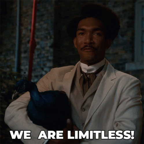 A Man In A Suit Holding A Peacock With The Words We Are Limitless Written Below Him GIF