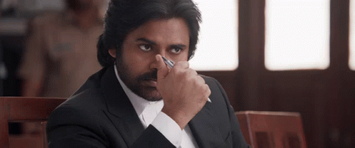 a man in a suit holds a pen in his hand