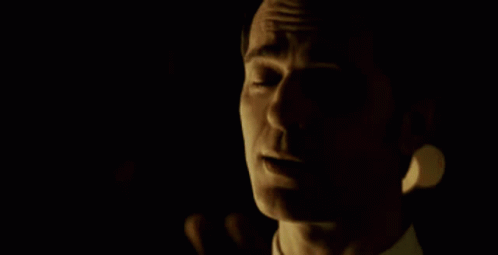A Man In A Suit Holds Another Man 'S Head GIF