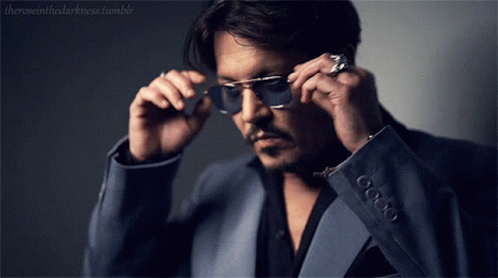 A Man In A Suit Is Adjusting His Sunglasses With The Words Theroseinthedarkness Tumblr In The Corner GIF
