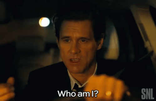 A Man In A Suit Is Asking Who Am I GIF