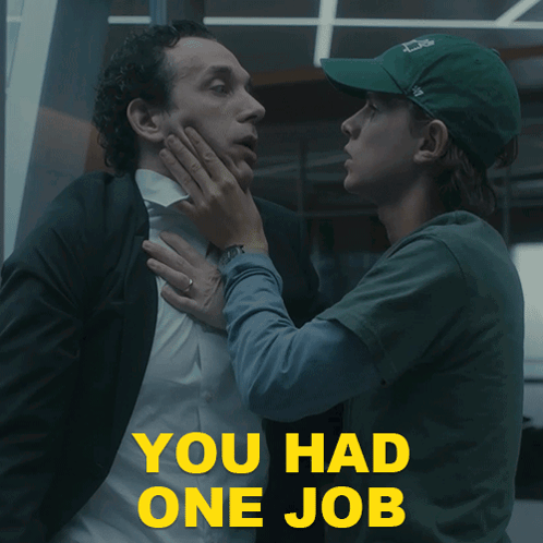 A Man In A Suit Is Being Held By A Woman In A Green Hat With The Words " You Had One Job " In Yellow GIF