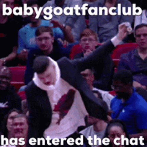 A Man In A Suit Is Being Thrown In The Air In Front Of A Crowd With A Caption That Says Babygoatfanclub GIF