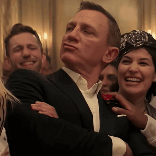 a man in a suit is being touched by a woman in a headband