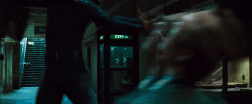 A Man In A Suit Is Brushing His Teeth With A Toothbrush . GIF