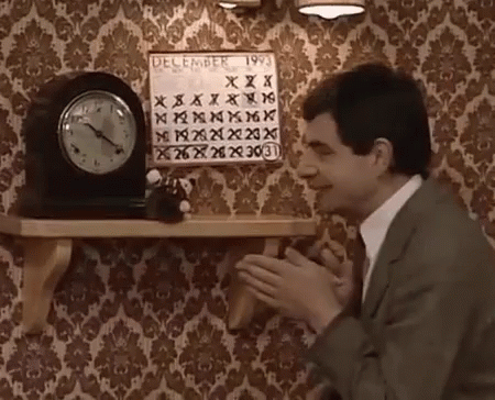 A Man In A Suit Is Clapping In Front Of A Calendar That Says December 1993 GIF