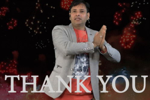 A Man In A Suit Is Clapping In Front Of A Thank You Sign GIF