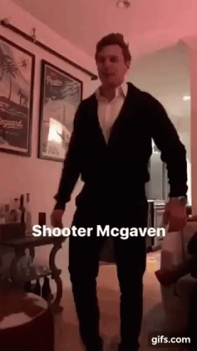 A Man In A Suit Is Dancing In A Living Room With A Caption That Says Shooter Mcgaven GIF