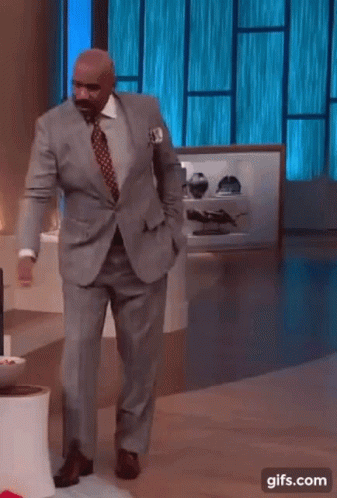 Man In Suit Dancing In Front Of Blue Window GIF
