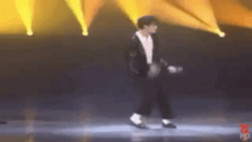 Man In Suit Dancing Under Yellow Lights GIF