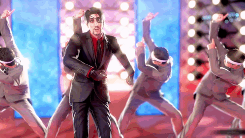 A Man In A Suit Is Dancing With A Group Of People GIF