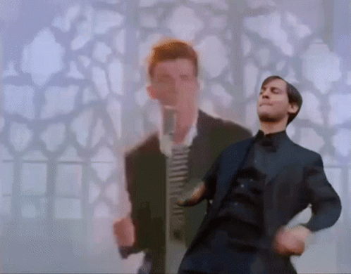 A Man In A Suit Is Dancing With Another Man In A Suit In The Background . GIF