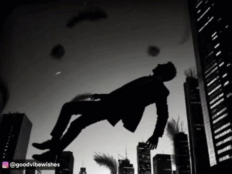 A Man In A Suit Is Falling Through The Air In A City GIF