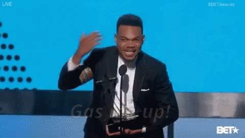 A Man In A Suit Is Giving A Speech At A Bet Awards GIF