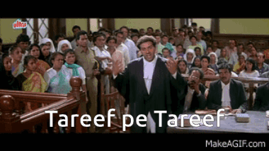 A Man In A Suit Is Giving A Speech In Front Of A Crowd With The Words " Tareef Pe Tareef " Written Below Him GIF