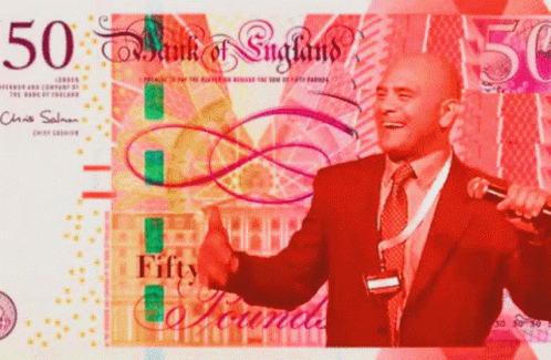 a man in a suit is giving a thumbs up in front of a 50 bank of england bill