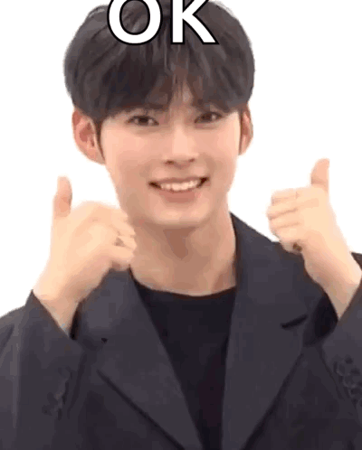 A Man In A Suit Is Giving A Thumbs Up Sign . GIF