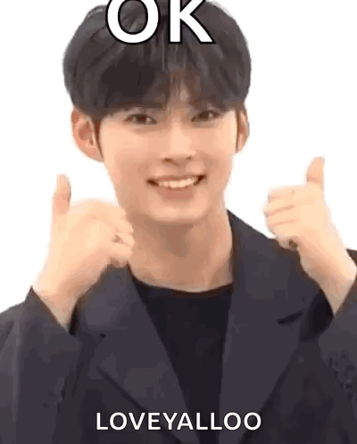 A Man In A Suit Is Giving A Thumbs Up Sign . GIF