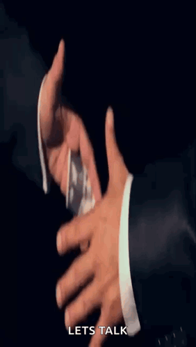 A Man In A Suit Is Handing Another Man A Stack Of Money With The Words Let 'S Talk Below It GIF