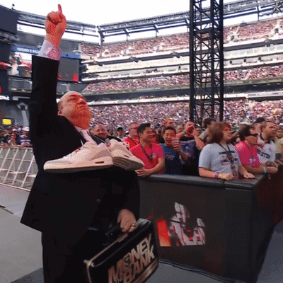 A Man In A Suit Is Holding A Briefcase That Says Money Bank On It GIF