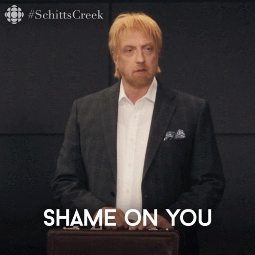 A Man In A Suit Is Holding A Briefcase With The Words Shame On You Below Him GIF