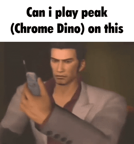 A Man In A Suit Is Holding A Cell Phone With The Words Can I Play Peak ( Chrome Dino ) On This Below Him GIF