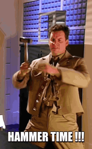 A Man In A Suit Is Holding A Hammer And Says " Hammer Time !!! " GIF
