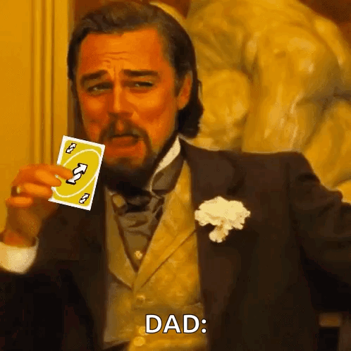 A Man In A Suit Is Holding A Uno Card In His Hand And Says Dad . GIF