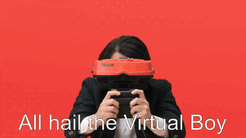 A Man In A Suit Is Holding A Video Game Controller And Says All Hail The Virtual Boy GIF