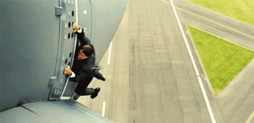 A Man In A Suit Is Jumping Off A Building Into The Air GIF