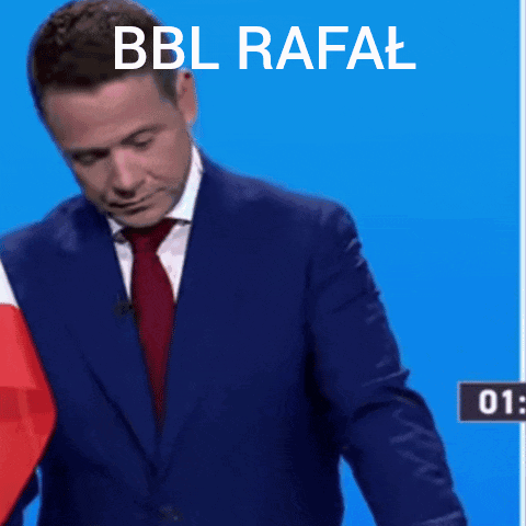 A Man In A Suit Is Kneeling At A Podium With The Words Bbl Rafal Written Above Him GIF