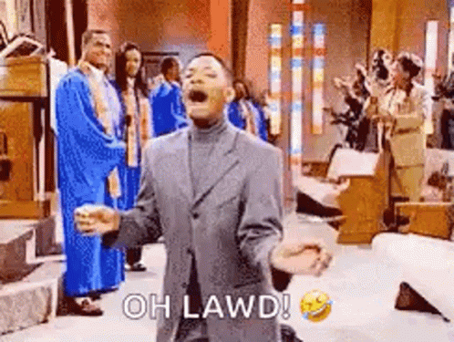 A Man In A Suit Is Kneeling Down In Front Of A Group Of People In A Church And Laughing . GIF