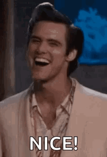 A Man In A Suit Is Laughing And Saying Nice . GIF