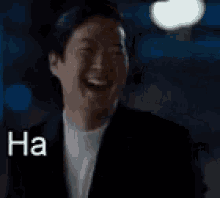 A Man In A Suit Is Laughing With The Words `` Ha Haaa '' Written Next To Him . GIF