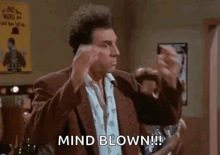A Man In A Suit Is Making A Funny Face And Says `` Mind Blown ! '' GIF